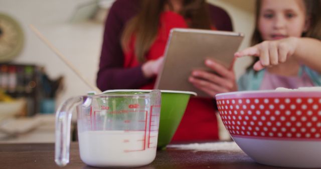 Mother and Daughter Using Tablet While Baking Together at Home - Download Free Stock Images Pikwizard.com