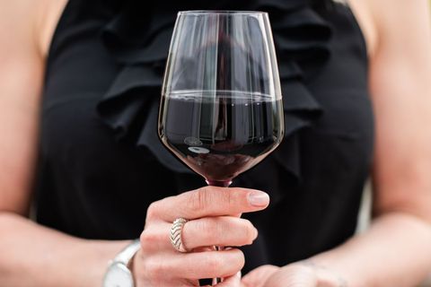 Woman Holding Glass of Red Wine with Elegance