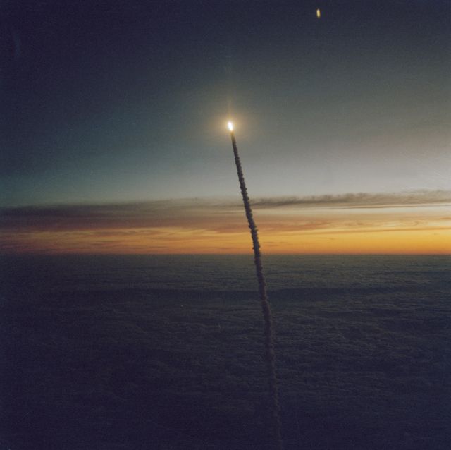 41G-90139 (5 October 1984) --- A Florida dawn scene forms the backdrop for the climbing Space Shuttle Challenger, its two solid rocket boosters and external fuel tank. Seven crewmembers, a space record, head for a busy eight-day stay in Earth orbit. The scene was photographed by astronaut Paul J. Weitz, who was piloting the Shuttle training aircraft (STA).