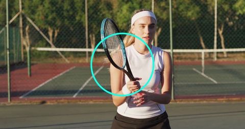 Woman Tennis Player Gripping Racket on Sunny Court