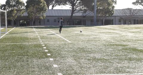 Soccer Player Practicing Skills on Sunny Field