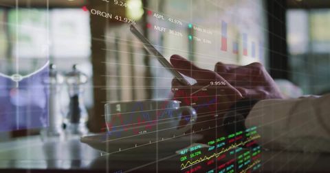 Man Analyzing Financial Data on Tablet with Graphs and Charts