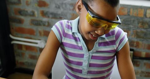 Young Girl Learning Electronics Soldering Wearing Safety Goggles