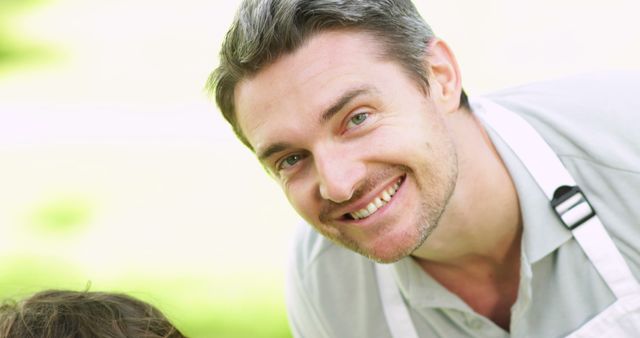 Smiling Man in White Apron Enjoying Outdoor Activity - Download Free Stock Images Pikwizard.com