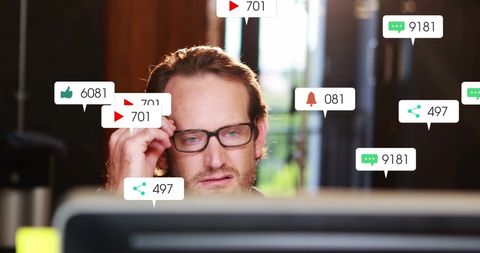 Businessman analyzing digital media notifications on computer