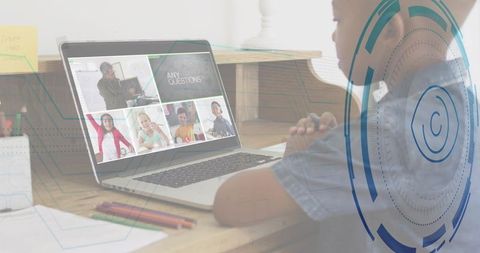 Young girl attending online class at desk with teacher on laptop and holographic UI