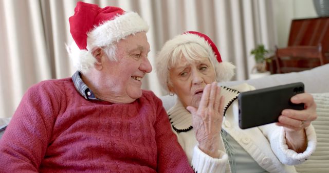 Happy Elderly Couple Taking Selfie in Santa Hats for Christmas - Download Free Stock Images Pikwizard.com