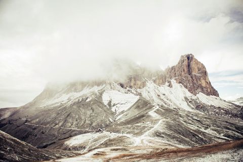 Misty Mountain Landscape with Snow Dusting and Winding Paths