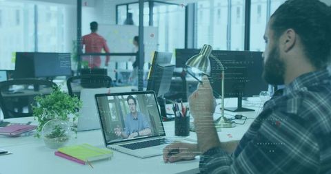 Professional Man Video Conferencing in Open Office Workspace