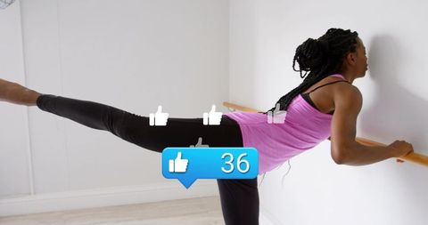 Woman holding barre and lifting leg in ballet fitness pose, studio balance and strength training