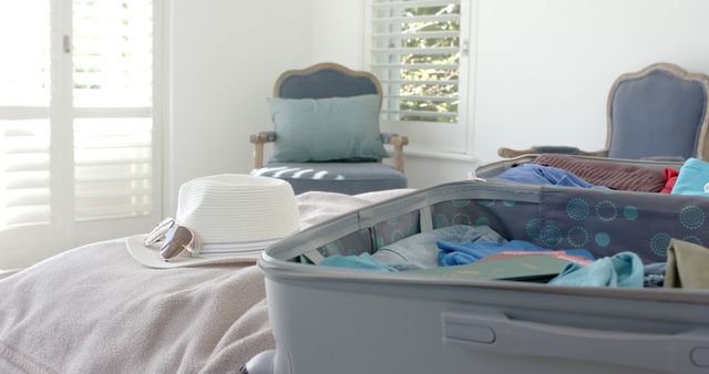 Open packed suitcase on tidy bed in modern bedroom - Download Free Stock Images Pikwizard.com