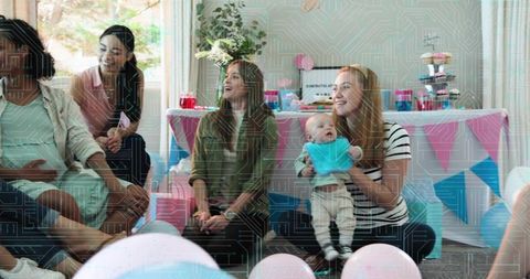 Smiling moms celebrating baby shower, mother holding infant with pastel party decor