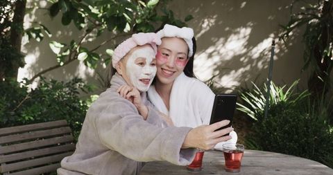 Senior and Younger Woman Enjoying Relaxation in Garden