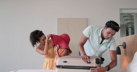 Couple Packing for Vacation Gets Ready for Trip