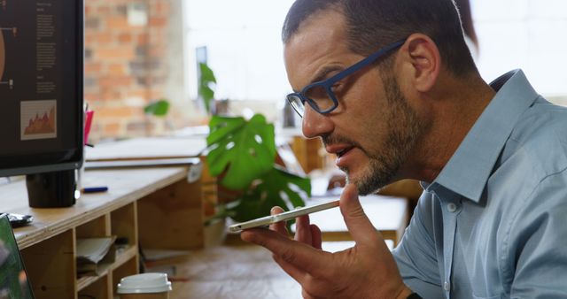 Businessman Using Smartphone Voice Function in Modern Office - Download Free Stock Images Pikwizard.com