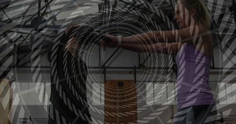 Reaching fitness duo connecting in partner training industrial gym with spiral overlay