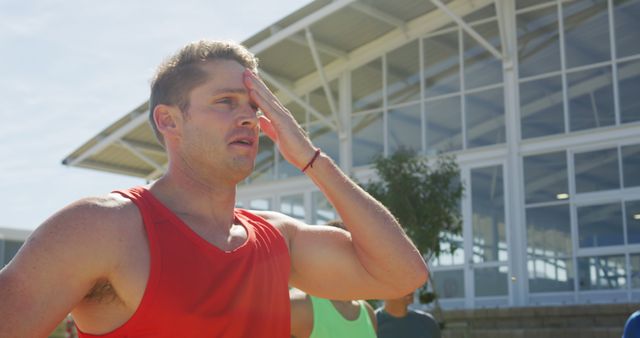 Young Man in Red Tank Top Wiping Sweat During Outdoor Workout - Download Free Stock Images Pikwizard.com