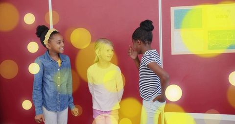 Diverse schoolgirls interacting in vibrant classroom setting