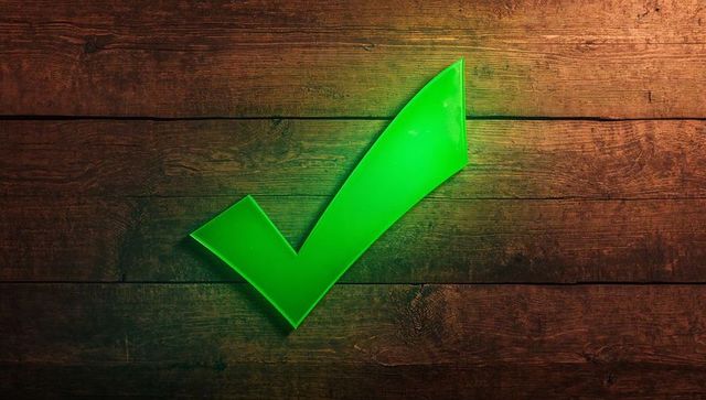 Glowing Green Check on Rustic Wood Background