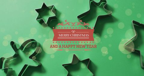 Christmas Greeting with Cookie Cutters on Green Background