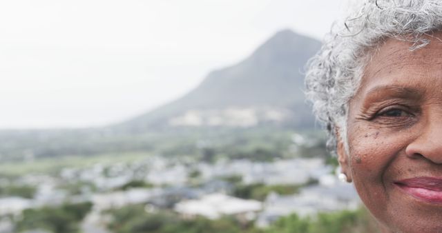 Smiling Elderly Woman Outdoors with Mountain View Background - Download Free Stock Images Pikwizard.com