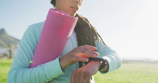 Young Woman Checking Fitness Tracker Before Outdoor Yoga Session - Download Free Stock Images Pikwizard.com