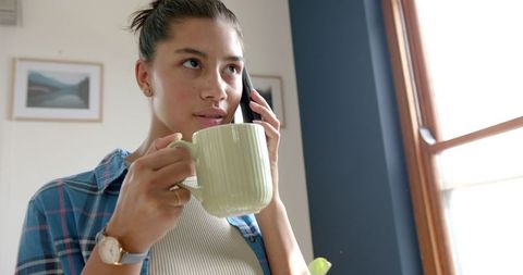 Teenage Girl Relaxing with Tea and Chatting on Phone