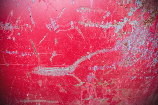 Scratches on red metal background, full frame