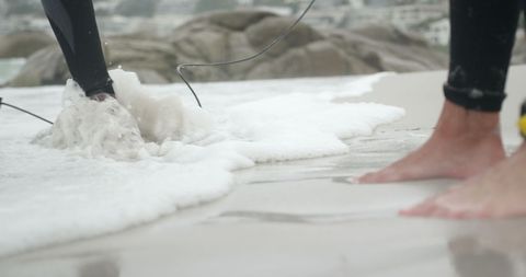 Surfers Gearing Up at Seashore, Footprints in Sand