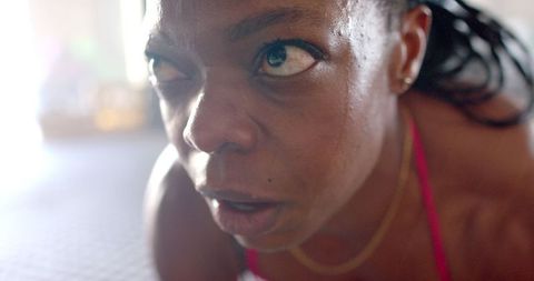 Close-Up of Determined Woman Exercising Intensity in Gym Setting