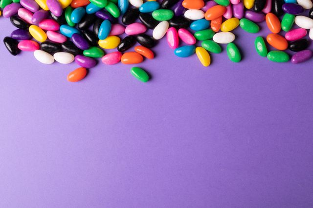 Colorful Candies on Purple Background with Copy Space - Download Free Stock Photos Pikwizard.com