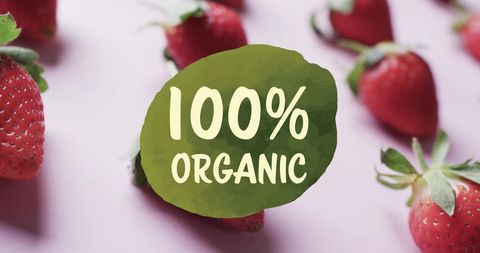 100 percent organic strawberries on pink background