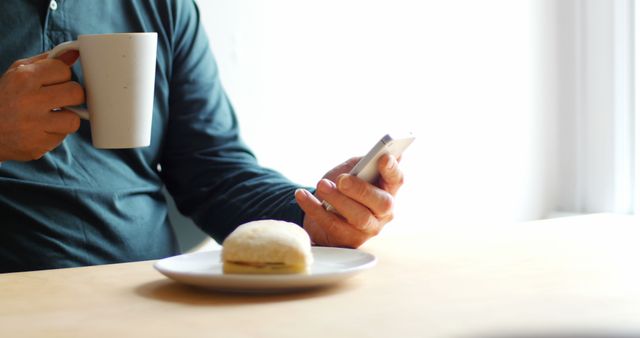 Person Drinking Coffee and Using Smartphone at Breakfast Table - Download Free Stock Images Pikwizard.com