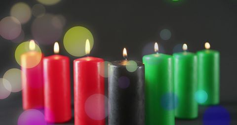Colorful Red Green and Black Candles with Light Spots