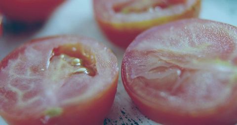 Halved Juicy Tomatoes Closeup Showing Seed Cavities and Glossy Flesh Macro Food Detail