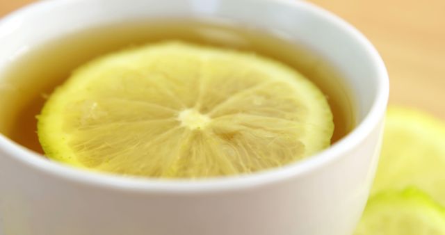 Close up of cup of tea with lemon and copy space on wooden background. Tea, food and drink concept.