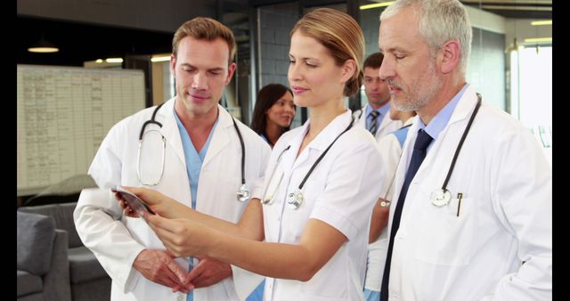 Team of Doctors Collaborating and Reviewing Medical Information on Digital Tablet - Download Free Stock Images Pikwizard.com