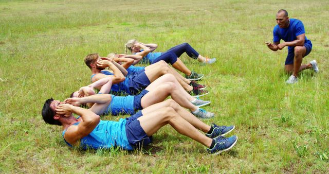 Fitness Coach Leading Group Workout in Outdoor Field - Download Free Stock Images Pikwizard.com