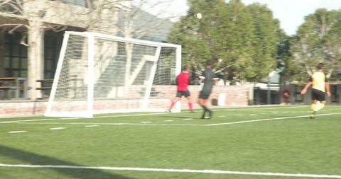 Soccer Players Practicing on Field, Showcasing Teamwork and Strategy