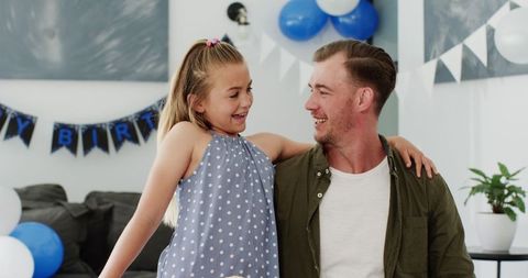 Father Celebrating Birthday with Smiling Daughter and Family