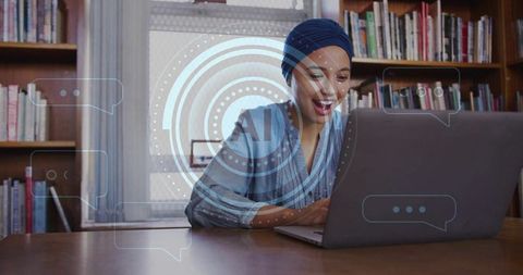 Woman studying on laptop in library with ai hud overlay, remote learning for research