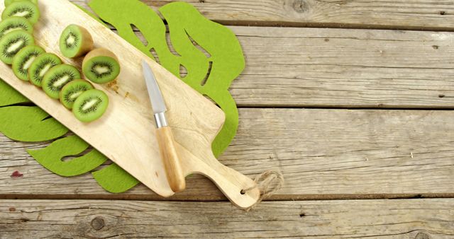 Freshly Sliced Kiwis on Wooden Cutting Board with Knife - Download Free Stock Images Pikwizard.com