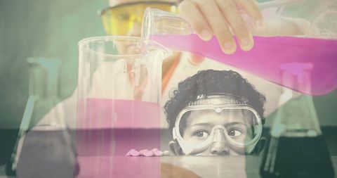 Child scientist experimenting with colorful chemicals in lab