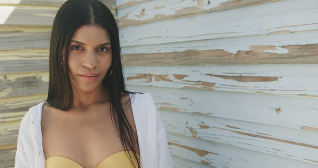 Confident Woman in Yellow Top Posing Against Weathered Wooden Wall - Download Free Stock Images Pikwizard.com