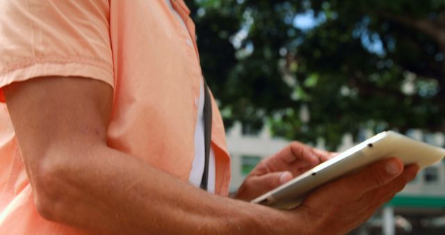 Person using digital tablet outdoors in summer - Download Free Stock Images Pikwizard.com