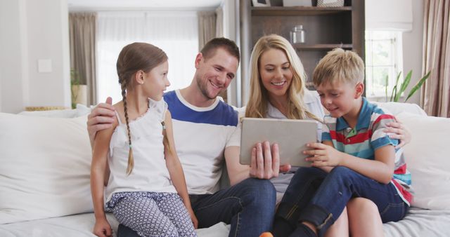 Happy Family Enjoying Digital Content on Tablet in Living Room - Download Free Stock Images Pikwizard.com