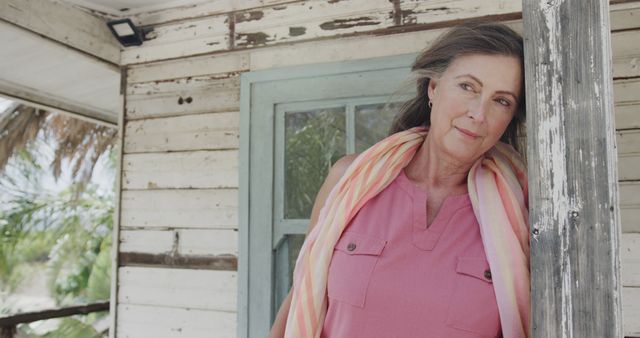 Senior Woman Resting Against Rustic Wooden Post on a Porch - Download Free Stock Images Pikwizard.com