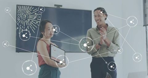 Celebrating woman receiving certificate in office with colleague clapping and network icons