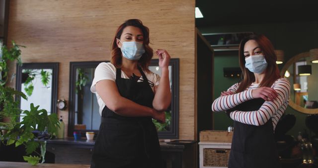 Female Hairdressers Wearing Masks in Salon Standing With Arms Crossed - Download Free Stock Images Pikwizard.com