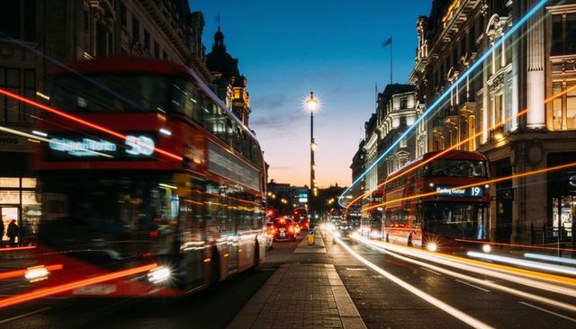 London evening rush long exposure with red double-decker buses and light trails